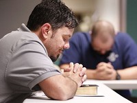 Adam Winn joins men in prayer after reading portions of 2 Peter from the Bible Thursday, October 5, 2017, at Trinity Life Ministry's rehab center in Crawfordsville. The group meets Monday and Thursday evenings. Staff photo by John Terhune