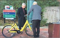Mayor John Hamilton, left, examines a type of bicycle that could be used in a bike share program with Indiana University. Staff photo by Kurt Christian
