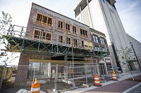 Work continues on the facade of the Hibberd Building, 320 S. Main Street in South Bend. The mixed-use building will include a rooftop terrace and is expected to be complete by September 2018. Staff photo by Michael Caterina