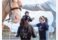 Brianna Poole, 14, pets Speck as she talks to officer Jeff Vantlin before a news conference to announce the start of the three-year Evansville Police Department mounted patrol. MARLENA SLOSS / COURIER &amp; PRESS