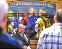 Art Jaggard, pastor at First Baptist Church, conducts the dedication of the refurbished stained-glass picture of Christ at the Anderson YMCA on Wednesday. Staff photo by  John P. Cleary 