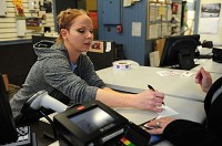 Tammy Bright helps a customer send a package at the Greenfield Post Office. Staff photo by Tom Russo