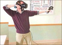 Bedford Public Library Youth Specialist Ryan Curto demonstrates the virtual reality technology that will soon be available for use at the library. Courtesy photo