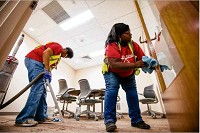 Gladys Williams and Shonna Winbush clean the inside of the Duncan Student Center on the University of Notre Dame&rsquo;s campus. They are two of 15 women from St. Margaret's House hired by My Best Friend Services for post-construction cleaning. Tribune Photo/MICHAEL CATERINA