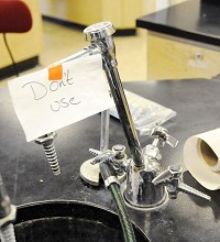 A sign warns students about a broken fixture in the chemistry lab at Alexandria-Monroe High School. Staff photo by Don Knight