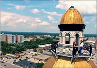  Spectacular vista: Linda Tichenor-Jeffries (left) and Lynn Hughes take in the view of Terre Haute from the cupola of the Vigo County Courthouse during the filming of the first video produced for The Haute Initiative. The project involving public and private partners will feature a series of videos on community assets and a comprehensive website, terrehaute.com, that locals, visitors and potential residents and employers can easily access. Image Courtesy Envisionary Media