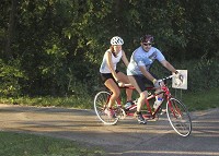 In this August 2017 file photo, Hannah Yeakey and her dad Michael Yeakey, both of Goshen, bike in tandem along the Pumpkinvine Nature Trail. City leaders are studying a plan to expand bicycle and pedestrian infrastructure in Elkhart and Goshen. Staff photo by Sheila Selman