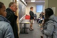It was standing room only as Indiana University Northwest Chancellor William J. Lowe and students listen to Rhiannon Carlson, a transgender woman who served in the U.S. armed fored during the 2003 conflict in Iraq. Staff photo by John J. Watkin