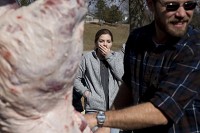 Jasper High School junior Anya Kerstiens reacted as teacher Andy Helming gutted a pig during his Advanced Life Science: Animals class' hog processing lab at the school on Monday. "I was not expecting that at all," said Anya. Staff photo by Sarah Ann Jump