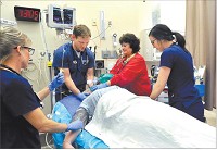 Heather Hall, RN, Dr. Ben Ricke, Dawn Shreves, RT, and RN Carlie Morlock work on a patient in the trauma unit of Community Hospital&rsquo;s Emergency Department. Community Hospital Anderson has been verified as a Level III Trama Center by the state.