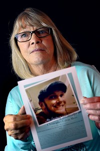 Sandra Young is shown here with a photo of her son, Christopher Moss, who died of an overdose in March 2017. &ldquo;The thought is in my head every day, all day long. &hellip;There&rsquo;s nothing &ndash; nothing ever will compare with losing a child," she said. Staff photo by Tim Bath | Kokomo Tribune