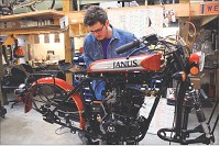 CAMERON GRUNTMAN of Goshen works to install a gas tank on a Janus Halcyon 250 model. Staff photo by Roger Schneider