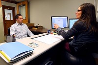 John Maher meets with his probation officer, Laura Rood. He must meet with her, pass drug tests and meet a wide variety of requirements in order to get through drug court. Staff photo by Tim Bath