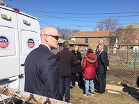 EPA chief Scott Pruitt and Gov. Eric Holcomb (at right) speak with a property owner Thursday behind her home where the agency has been testing soil at homes in the area.