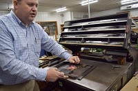 Jerry Zeigler, who owns Ewing Printing in Vincennes with his father, Jim, explains some of the old techniques used in commercial printing today. Staff photo by Jess Cohen