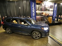 Steve and Luther peer out the windows at associates gathered as the first new Subaru Ascent rolls off the assembly line Monday, May 7, 2018, at Subaru of Indiana Automotive in Lafayette. Staff photo by John Terhune