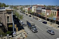 Cars and a truck drive down Main Street Monday afternoon in downtown Goshen. The city is considering making changes to Main Street, which include plans to change the road to two lanes and add diagonal parking. Staff photo by Ben Mikesell 