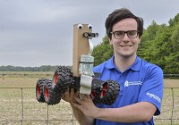 Prototype: Indiana State college of technology graduate student Parker Kirby holds up a thumper robot that was built to test the theory of the Sycamores&rsquo; robot they hope to bring to next year&rsquo;s agBOT Challenge. Staff photo by Austen Leake