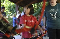 First-year camper Emma Blake, 9, tries her hand at archery Thursday during Camp About Face at Bradford Woods. Staff photo by Chris Howell