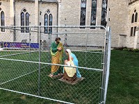 Christ Church Cathedral on Indianapolis' Monument Circle has locked up the Holy Family on its lawn to protest Trump administration policies that have led to the detention of thousands of children and families seeking asylum in the United States. Staff photo by Dan Carden