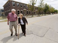 Michael and Phyllis Hunt walk back to their home after checking on the progress of the Centennial Townhomes (background) under construction Friday, July 28, 2017, at N. Sixth and Cincinnati streets in Lafayette. The couple are long-time residents of the Centennial Neighborhood. Staff photo by John Terhune/Journal &amp; Courier)