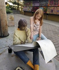 Emilia Pickett of Millersburg looks at a Seward Johnson sculpture of an artist that is on display in Goshen's Art Allen. Contributed photo