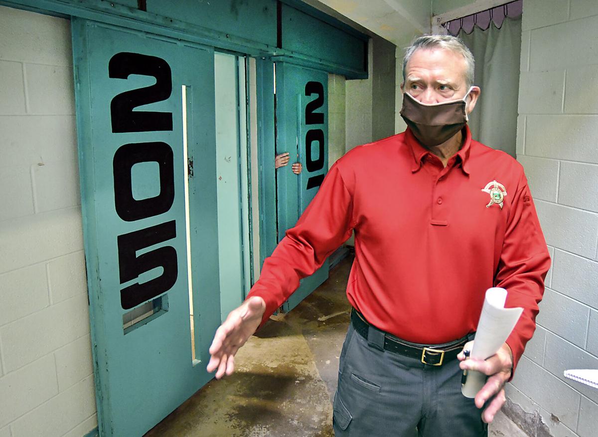 Madison County Sheriff Scott Mellinger shows some of the maximum security doors that are malfunctioning in this cell block of the jail. The door for cell 205 will only close half way, and cell 207 will not close tightly, leaving a large gap where inmates can get their hands through. John P. Cleary | The Herald Bulletin