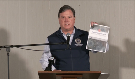 Attorney General Todd Rokita waves a release from his office criticizing state actions taken during COVID-19. (Screenshot from video)