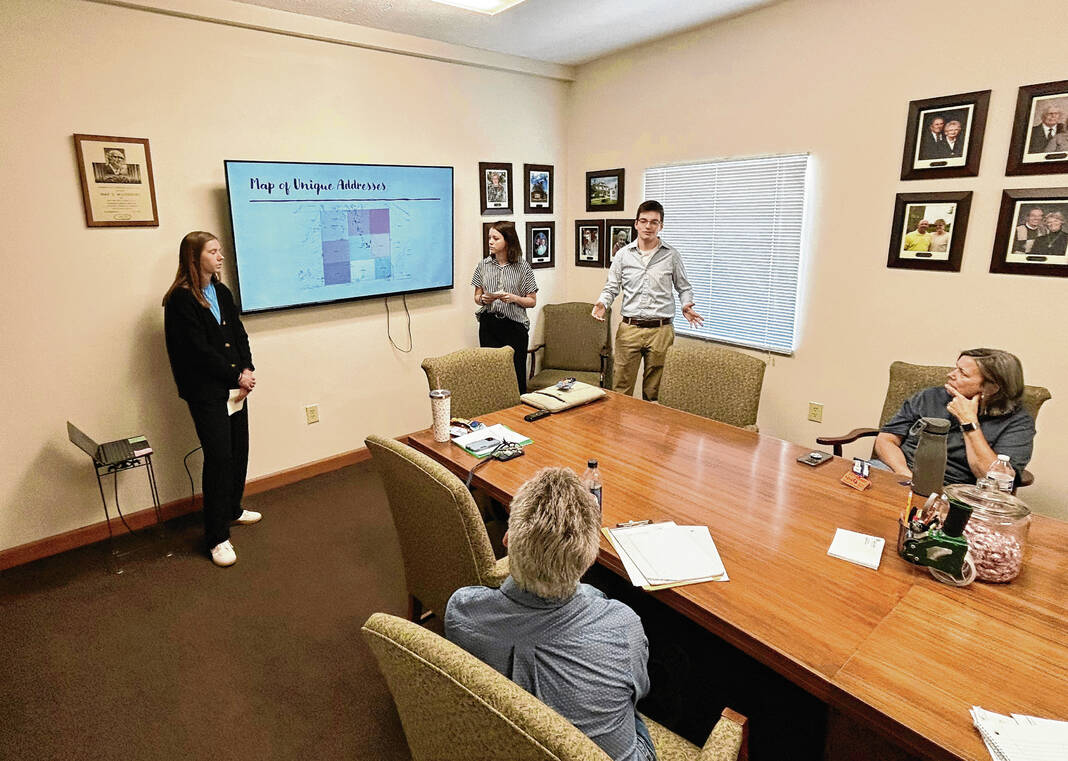 From right, Blake Talbert, Lilyanna Slaven and Dianna Rollag, all Franklin College students, give a presentation on where Interchurch Food Pantry clients come on April 26 at the food pantry as part of the college’s Statistical Consulting Project course. 
RYAN TRARES | DAILY JOURNAL