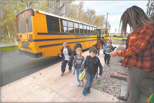 Howard Elementary students arrive at school April 25. School districts, in the face of high rates of absenteeism, have turned to making personal connections with parents and students, as a way to increase attendance. Photo by Tim Bath | Kokomo Tribune