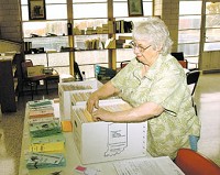 Dorothy Stewart, a 50-year resident of the Muscatatuck State Developmental Center, sorts through employee information folders. See her story below. 
Photo by Mike Dickbernd