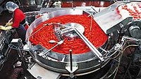 Tomatoes go around a pocket filler before dropping into cans Tuesday at the Red Gold plant in Orestes. Photo by Kurt Hostetler