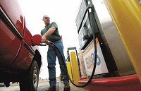 Robert Pasley, of Rensselaer, fills his tank Monday with E-85 fuel at the Gas City station on U.S. 30 at Ind. 51 in Hobart. The station now has a pump dedicated to servicing users of the ethanol-based blend, a first for the region. JOHN LUKE | THE TIMES