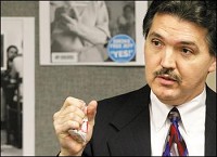 Jeffersonville resident Lonnie Cooper crushes a pack of cigarettes in his hand during a Southern Indiana Smoke-free coalition press conference Wednesday afternoon asking Mayor Rob Waiz to sign the partial smoking ban into law. Mayor Waiz signed the ordinance Wednesday. Staff photo by C.E. Branham