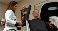 Path to health: Ball Memorial Hosiptal Cancer Center cardiovascular oncology rehab specialist Lindesy Hanna checks the blood pressure of lung cancer patient Jack Vice as he works out at the center. KURT HOSTETLER / THE STAR PRESS