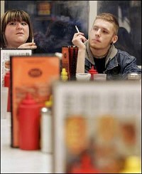 Sunni Neff and Joseph Lane smoke at Triple X in West Lafayette. The owner of the restaurant is against the proposed smoking ordinance. By Frank Oliver/Journal and Courier