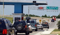 Vehicles line up for entry tickets to the Indiana Toll Road at the South Bend west gate on a busy Fourth of July weekend. Paul Rakestraw/South Bend Tribune