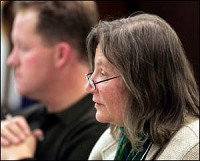 Patti O'Callaghan and Randy Truitt (above) of the West Lafayette City Council listen to discussion Monday night on a proposed ordinance banning smoking in nearly all city workplaces and indoor public areas. She voted for it and he voted against. By Frank Oliver/Journal and Courier)