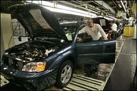 Subaru of Indiana Automotive Inc. workers Tom Rudisaile (standing) and Dave Nephew (in door) work on the line at the plant in Lafayette. It was announced Monday that the Toyota Camry will be built at the the plan. By Michael Heinz/Journal and Courier