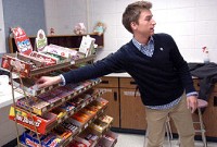 Seth Dager grabs candy while working at the student council snack counter Wednesday at Homestead High School. Cathie Rowand/The Journal Gazette 