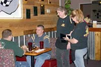 Waitresses Leona Callaway and Sarah Bradburn talk to customers at Squealers Barbecue in Mooresville. Some customers appreciate the smoke-free environment, but the owner says many of his lunch customers who smoke now go to restaurants in Hendricks County. Amy Hillenburg | Hoosier Times