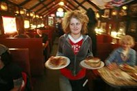 Server Sandi Myers hustles through the lunch hour Wednesday at Nick’s English Hut in Bloomington. Business at Nick’s is booming; the restaurant’s revenue is up 15 percent from last year. Jeremy Hogan | Herald-Times