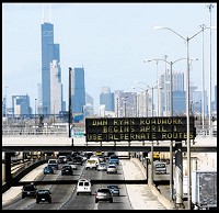 Downtown Chicago looms ahead as traffic continues westbound on the Dan Ryan expressway near the 59th Street overpass, where an electronic sign warns drivers that roadwork begins April 1 and alternate routes should be used. (Stephanie Dowell / Post-Tribune)