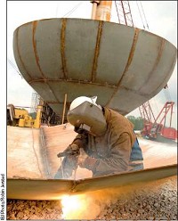 A worker for Phoenix Fabricators welds panels for a 200,000-gallon water tower under construction on River Road in Carmel.