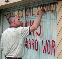 
David Dietrich, 45, paints a sign on the window of his dry-cleaning business Wednesday, thanking local officials for their efforts to attract Honda to Van Wert. Honda announced it would build a plant in Indiana.&nbsp;&nbsp;Angela Mapes/The Journal Gazette 