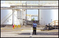 Storage containers holding biodiesel fuel at Wolf Industrial Center in Hammond are guarded by Mark Zareer. (Leslie Adkins / Post-Tribune)