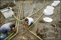 Justin Rehwinkel (left) and Steve Allen of W.G. Gentry Co. Tank Installation and Pump Repair look over piping Wednesday for the new E85 and biodiesel pumps. The alternative fuels will soon be available in Reynolds. By Andrew Hancock/Journal &amp; Courier