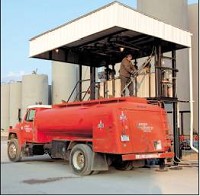 Kevin Wright of Jackson Oil and Solvent fills his delivery truck at the firm’s south-side depot.