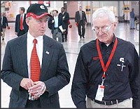 Gov. Mitch Daniels, left, walks through Cummins Plant 1 with Daimler-Chrysler representative Roger Lang following the announcement of 600 new jobs at Plant 1 today. The Republic photo by Joe Harpring.