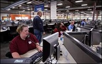 Sallie Mae project manager Jessica Oshier and others test the new computer system at Sallie Mae by making a few live calls from the new center in Muncie. Kurt Hostetler / The Star Press